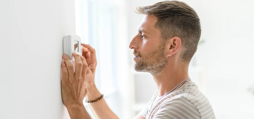 uomo che regola il climatizzatore